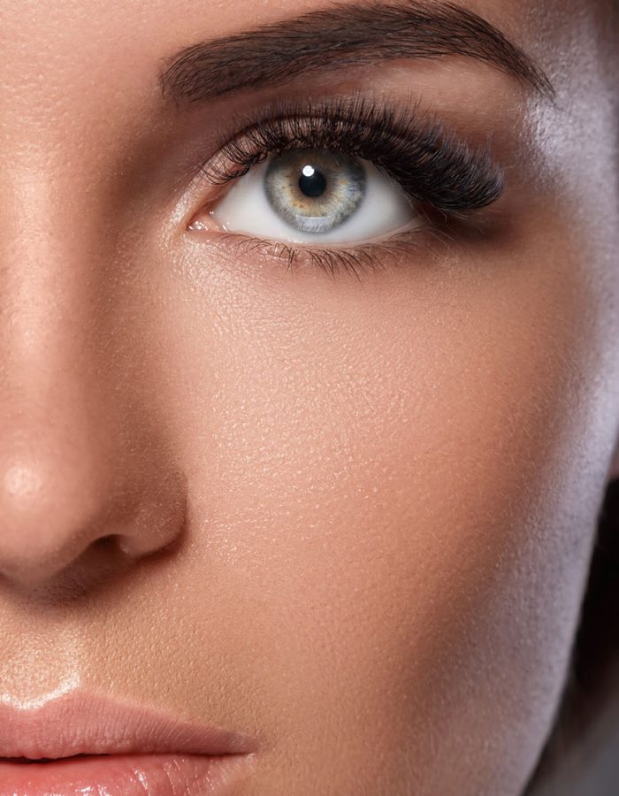 Female face with beautiful eyebrows and artificial eyelashes for maximum volume